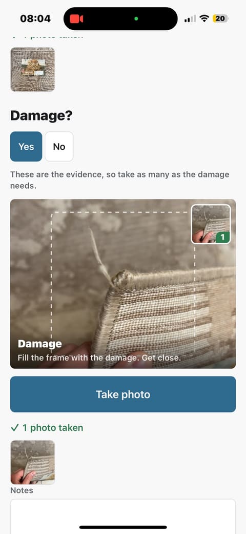 The damage step: a thumbnail of the care label already photographed, a Damage? Yes/No choice with Yes selected, and a viewfinder filled with a frayed corner of the rug where the fringe has pulled away.